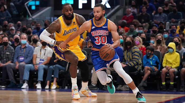 LeBron James defends Stephen Curry in a game.